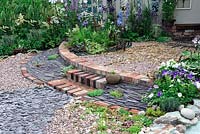 Semi circular patio using bricks, slate, gravel and pebbles. Garden Gallery. RHS Tatton Park Flower show 2013