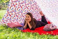 Girl relaxing in a garden tent