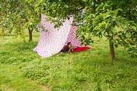 Girl relaxing in a garden tent