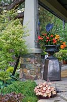 Flowerbeds and containers with Heuchera, Tsuga, Acer, Colocasia Black Magic', Begonia 'Dragon Wings', Coleus 