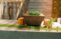 Vegetable garden in metal container also used as table.
