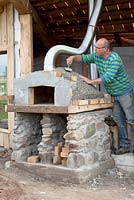 Man building a pizza oven