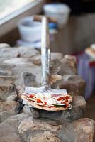 Pizza on spade waiting to go in the pizza oven