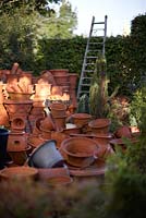 Whichford Pottery.  Pile of hand thrown terracotta pots in the morning sun.