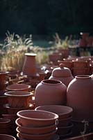 Hand thrown terracotta pots at sunrise.