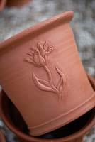 Hand thrown terracotta pot with tulip design.