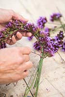 Tying Verbena bonariensis together with twine, to form a wreath