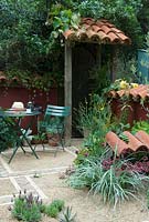 Table and chair in Mediterranean style courtyard - Chelsea Flower Show 2007