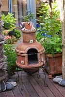 A chiminea on decked terrace in small town garden, Brighton, UK 