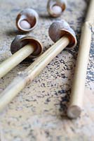 Step by step of making snail shell cane toppers - Push the narrow end of the bamboo canes up inside the shells to make contact with the modelling clay to secure in place