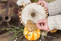 Filling pumpkin with sunflower seeds - making bird feeder 