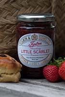 Tiptree 'Little Scarlet' Strawberry Jam in a jar with a scone and strawberries