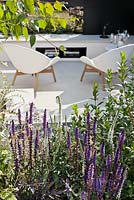 Outdoor living room. Flowerbeds with Salvia nemerosa 'Caradonna', Veronica longifolia 'Scheeriesin' 