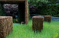 Stockton Drilling as Nature Intended Garden, Silver gilt medal winner, Chelsea Flower Show 2013. Woven willow sculptures in long grass
