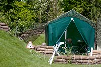 Tent in garen setting. Rhododendron ponticum, Gunnera tinctoria, Fallopian japonica, Buddleia davidii, Crocosma x croccosmiiflora, Fuschia magellanica, Stipa arundinacea. All plants have been sourced within Ireland and have been selected from the top ten most wanted list or most potential threat