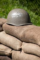 Make a garden not war - message on army hat and sandbags 