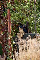 Scarecrow with crow in the cornfields.