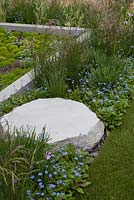 Rock in flowerbed next to raised bed - Sentebale Forget-Me-Not Garden - RHS Chelsea Flower Show 2013

