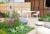 The Brewin Dolphin Garden -  contemporary garden with polished concrete boulders, water bassin, sculpture, table and chairs