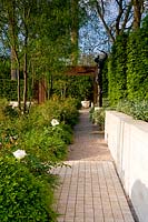 Laurent Perrier garden - raised canopy with shady planting beneath. Straight brick and gravel path 