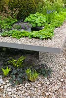 Split level gravel garden with mirrored panels in The First Touch Garden at RHS Chelsea Flower Show 2013