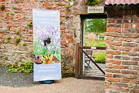 Entrance to nursery in walled garden with National Park banner. Chipchase Castle Nursery, Wark, Northumberland, UK