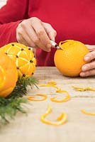 Using lino cutter to make pattern in orange peel