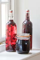 Home grown preserves in glass bottles and a jar
