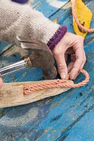 Attaching rope handle. 