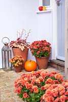 Front door decoration decorated for autumn with squashes, pumpkins, chrysanthemums 