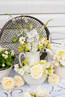 White-themed summer floral arrangement - roses, alchemilla mollis, linaria, delphinium, margerites, begonia, sweet peas