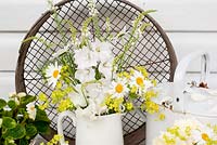 White-themed summer floral arrangement - sweet peas, alchemilla mollis, linaria, delphinium, margerites, begonia