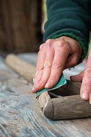 Sanding down wooden parts of fork to remove any splinters and prepare for oiling