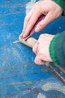 Sanding down handle of Hand Fork to remove any splinters and prepare for oiling