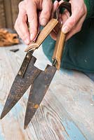 Sanding down handle of Hand Shears to remove any splinters and prepare for oiling