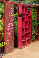 Pergola made of red painted wineboxes and winecork decoration. 