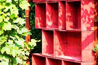Pergola made of red painted wineboxes. 