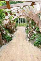 Path under pergola made of wooden frames. 