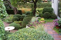 View from the terrace with Buxus sempervirens and Taxus baccata. The garden of Swedish garden designer and editor Ulla Molin 1909-1997 in Hoganas, Sweden, in 1996 when Ulla Molin was still alive.  