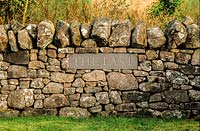 Plaque set into wall - The Last. Little Sparta, Dunsyre, Lanark, Lanarkshire. Scotland. 
