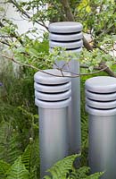 Artificial towers made to represent chimneys. Cornus florida and Matteuccia struthiopteris. Show Garden: RBC Blue Water Roof Garden. 