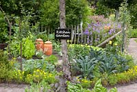 Kitchen garden with sign hanging on tree