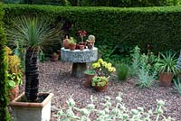 Succulent plants in containers arrangement and millstone table