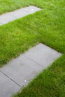 Lawn with stepping stone slabs. 