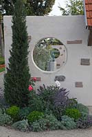 Window in wall with conifer border