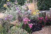 Seaside themed front garden with decorative driftwood and planting includes Phlox, Fuschia, Heuchera, Verbena and Stipa tenuissima