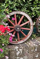Decorative rustic wooden wheel on wall