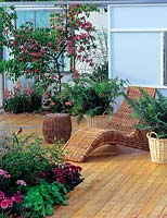 Cane furniture - decking area in outdoor garden room 