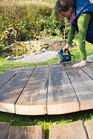 Using a jigsaw to cut decking to shape. 