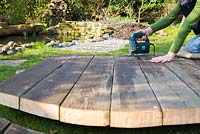 Using a jigsaw to cut decking to shape. 
